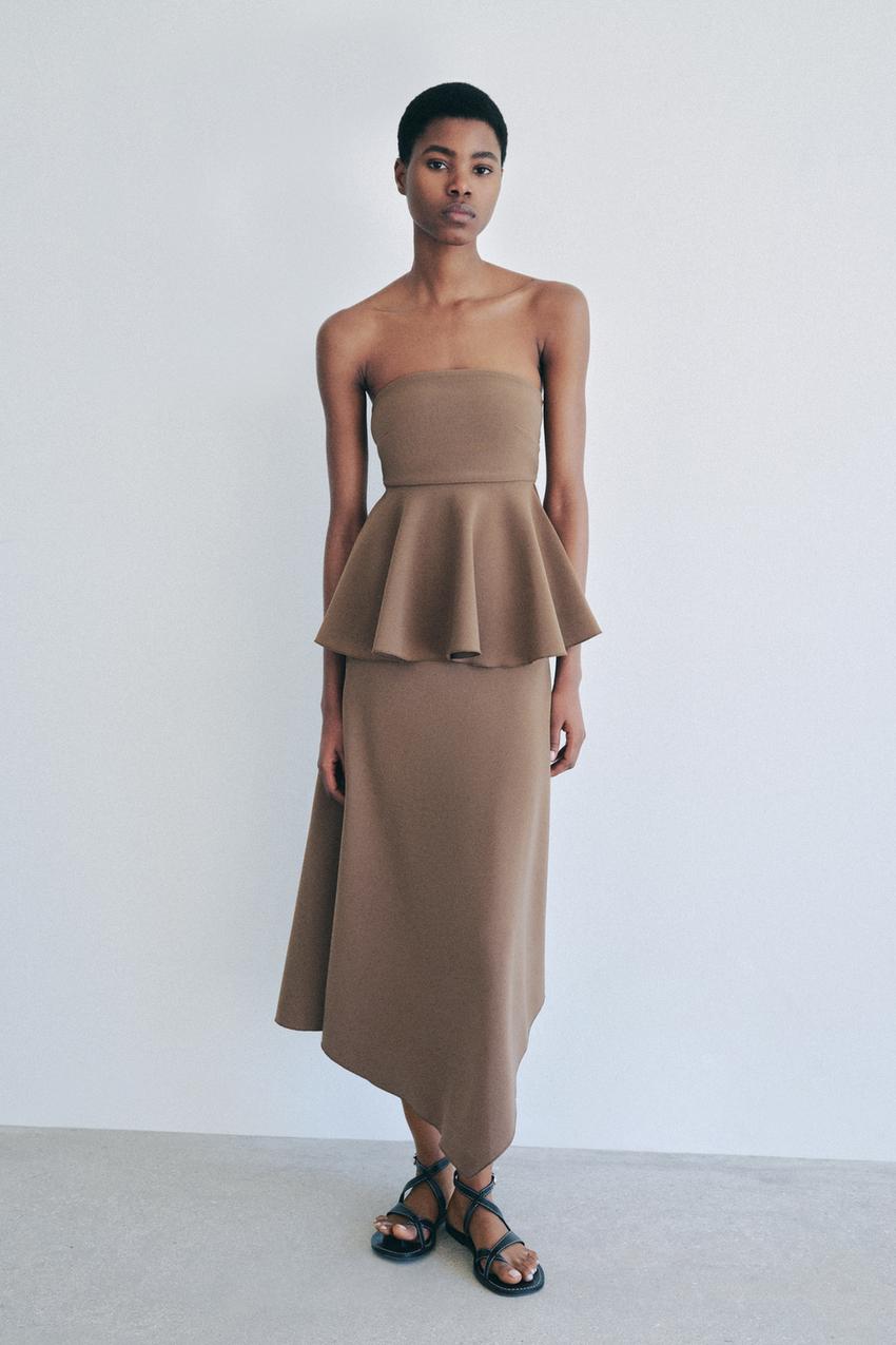 Taupe silk midi skirt with a matching strapless top on a model