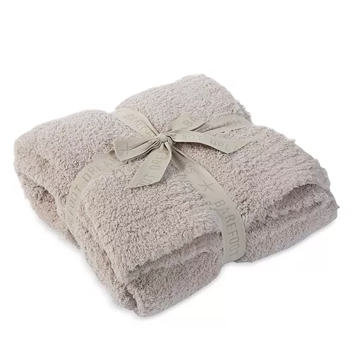 Taupe folded throw blanket with ribbon around it.