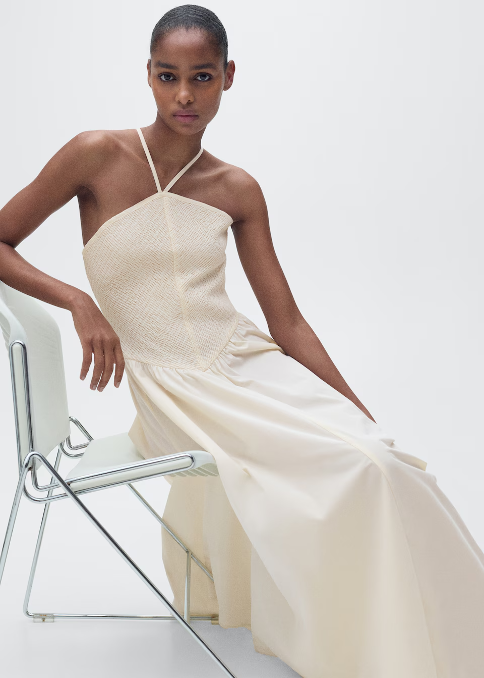 Cream halter maxi dress on a model.