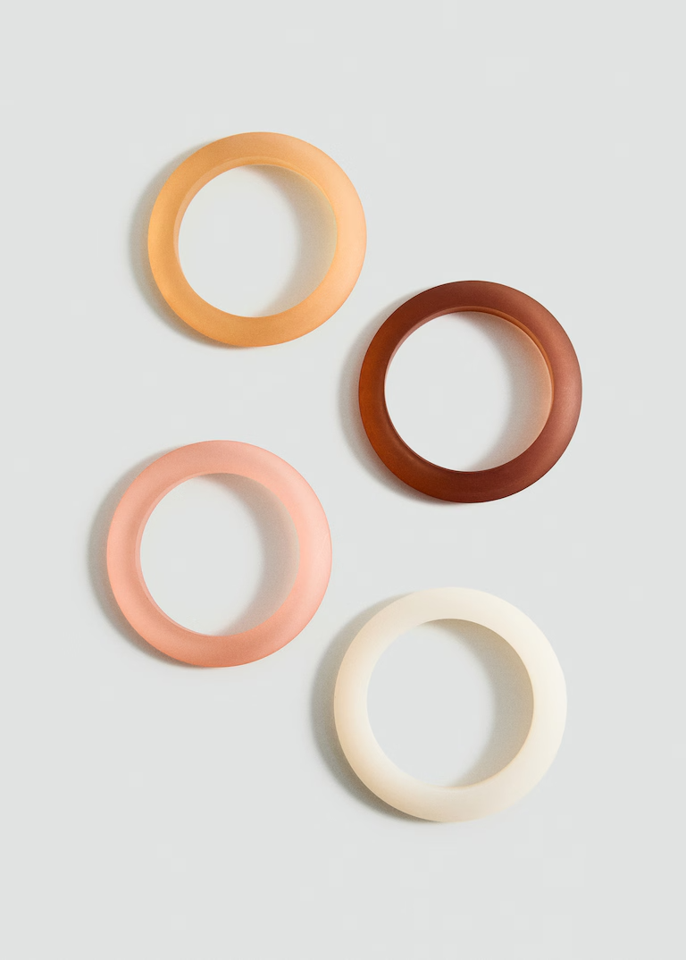 Set of 4 tan, brown, pink, and white bracelets.