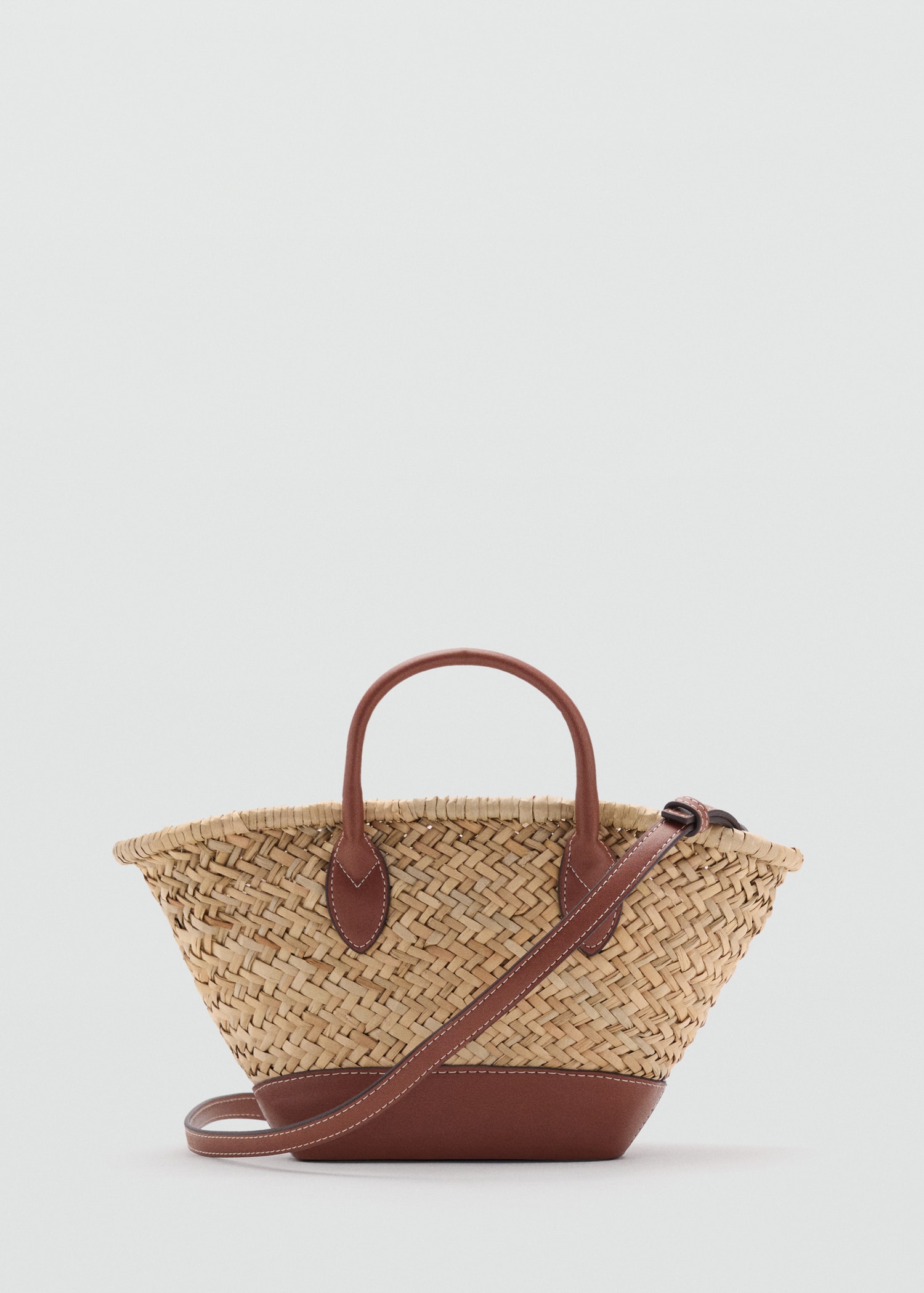 Tan raffia and brown leather bag with crossbody strap.