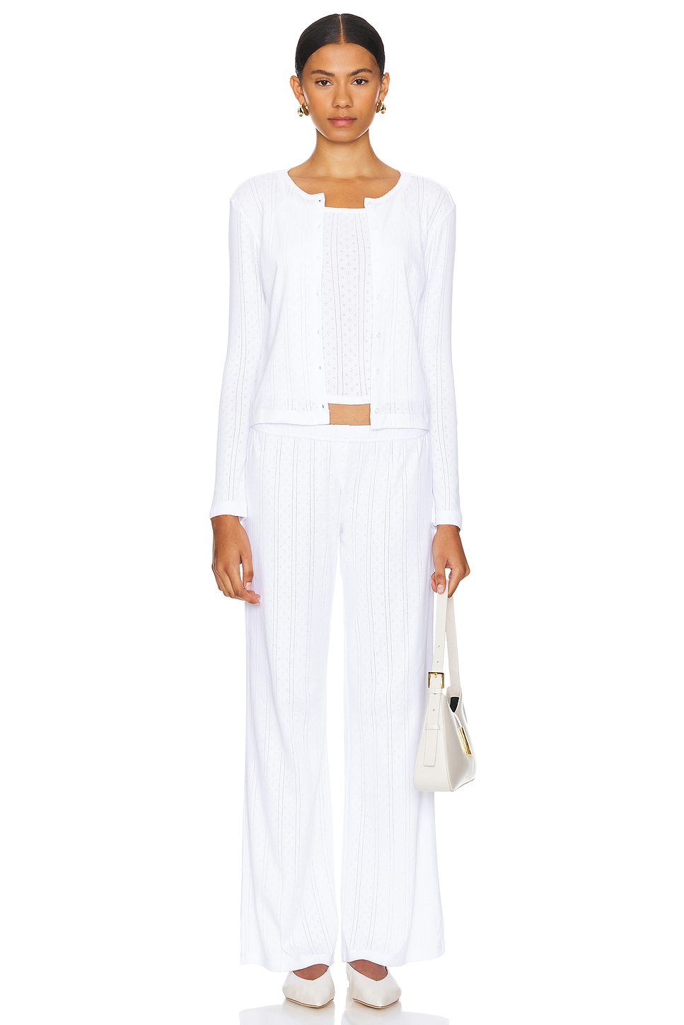White knit cardigan with matching pants on a model.