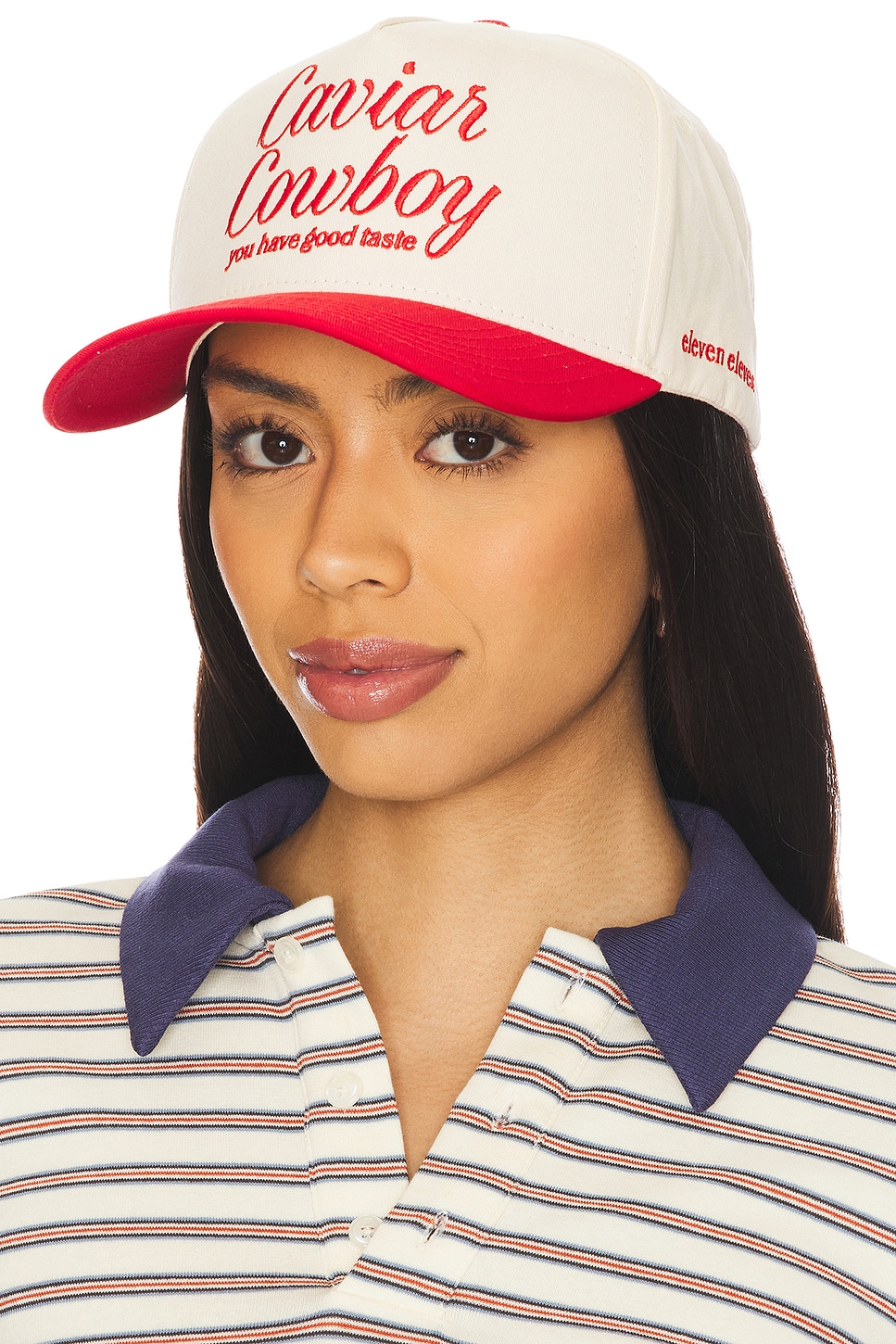 Off white and red cap with "Caviar Cowboy" text on a model.
