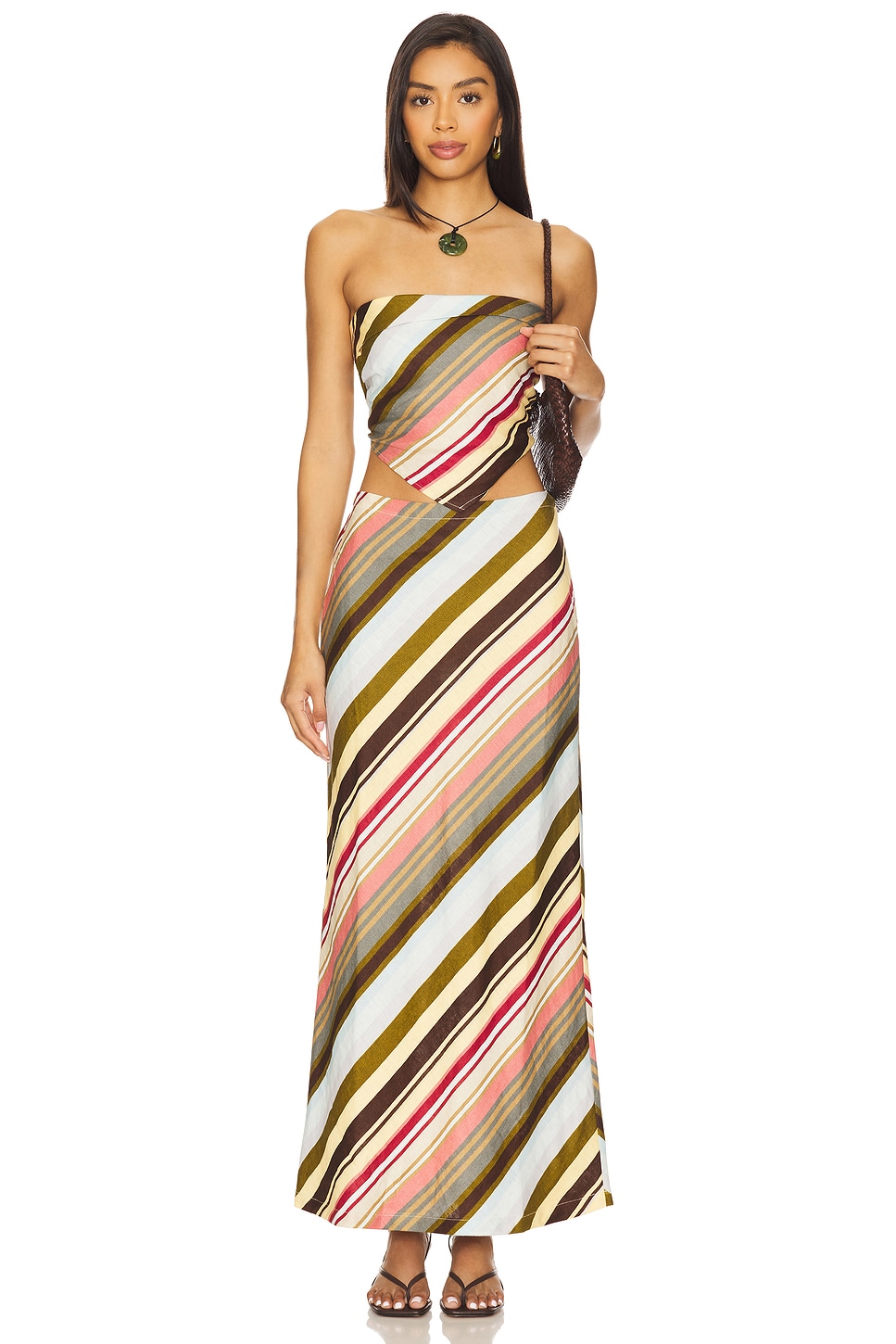 Multicolor striped strapless top and maxi skirt on a model.