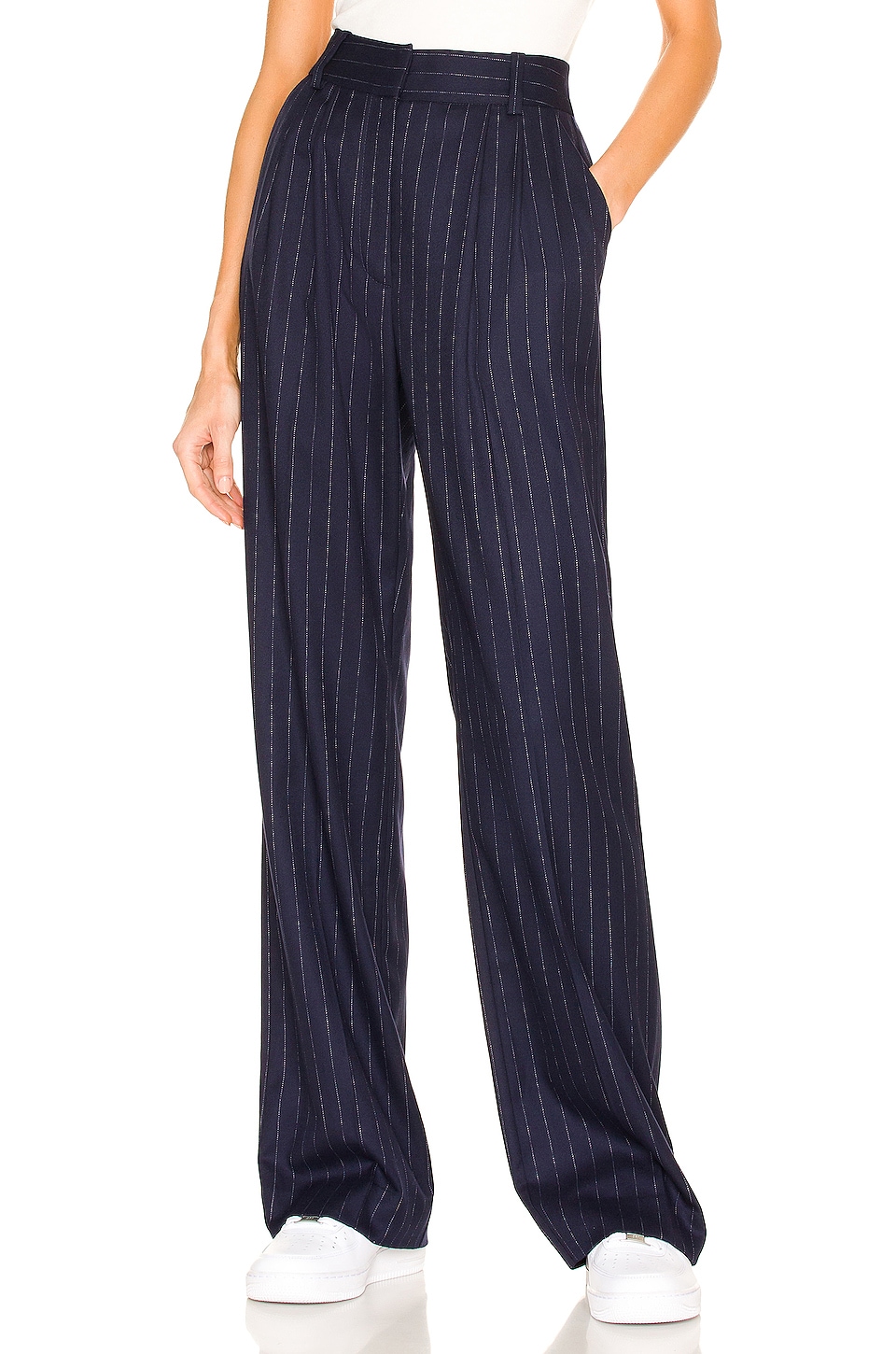 Navy blue and white pinstripe trousers on a model.