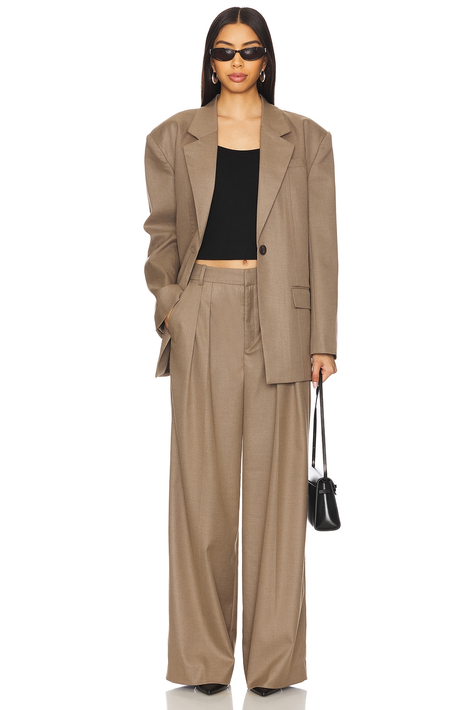 Brown blazer and matching dress pants on a model.