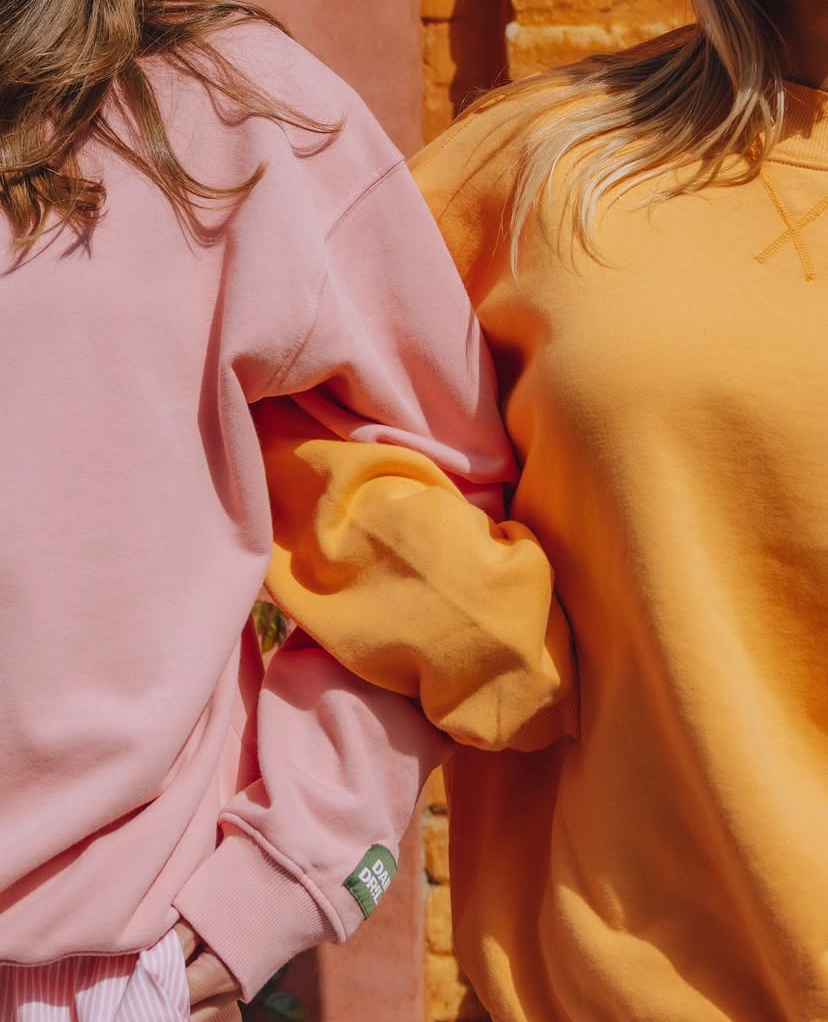 Daily Drills light pink and orange crewnecks.