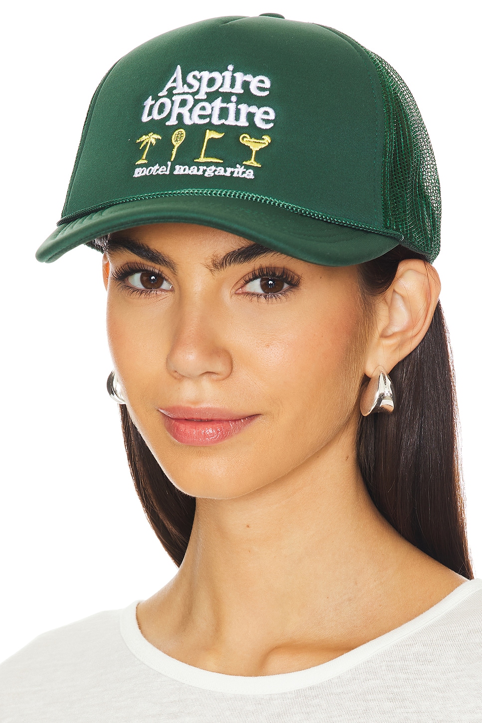 Green trucker har with yellow designs and text that says "Aspire to Retire" on a model.