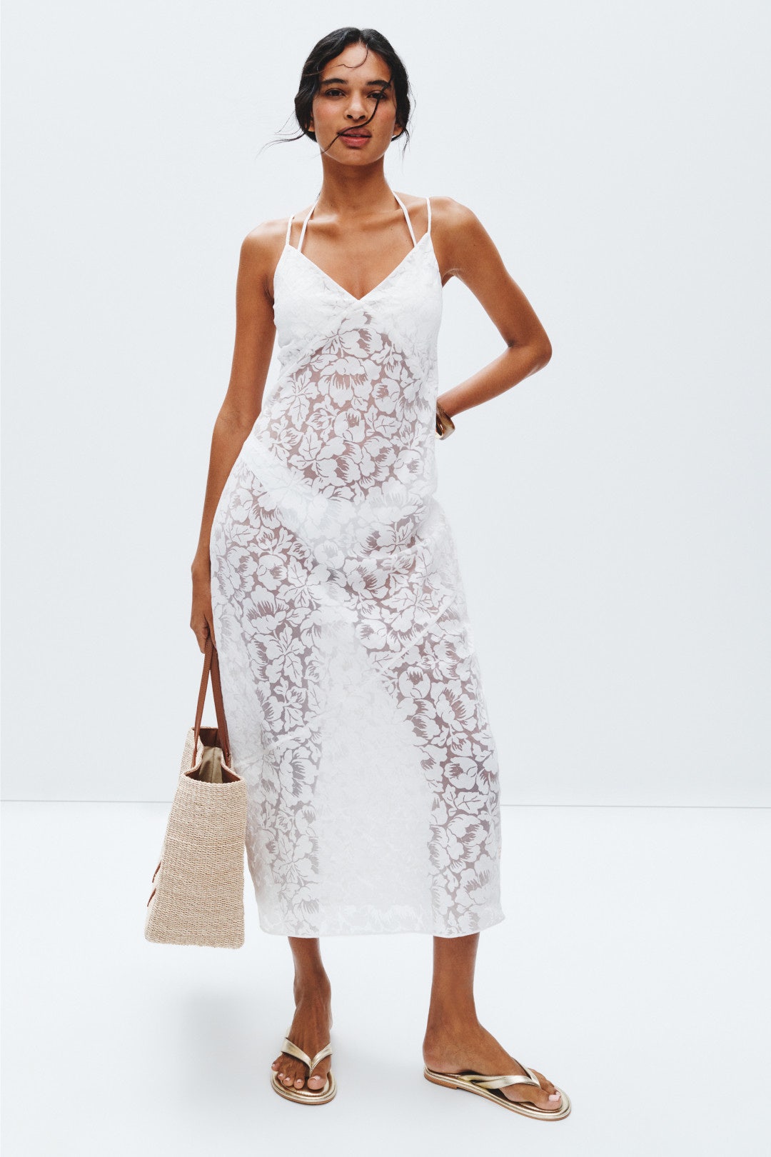 White floral print swimsuit cover up on a model.