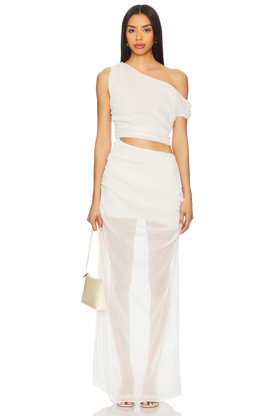 White off the shoulder maxi dress with a cutout on a model.