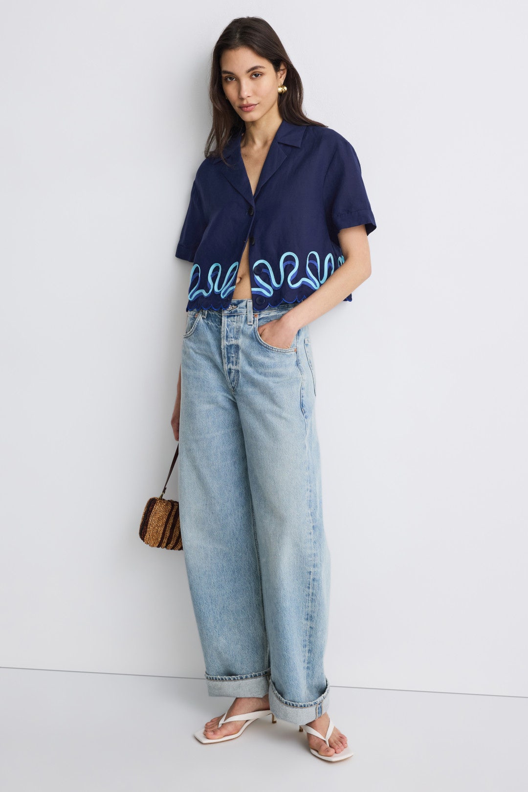 Navy short-sleeve button up with blue detailing on a model.
