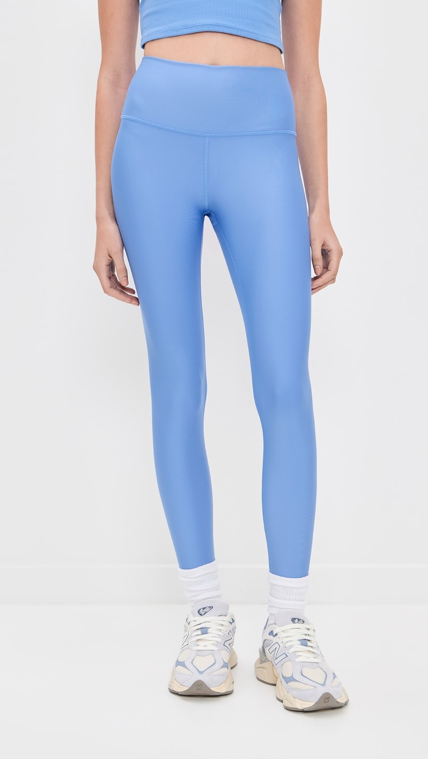 Light blue shiny leggings on a model.
