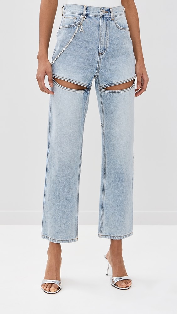 Blue denim slit jeans with a rhinestone strap on a model.