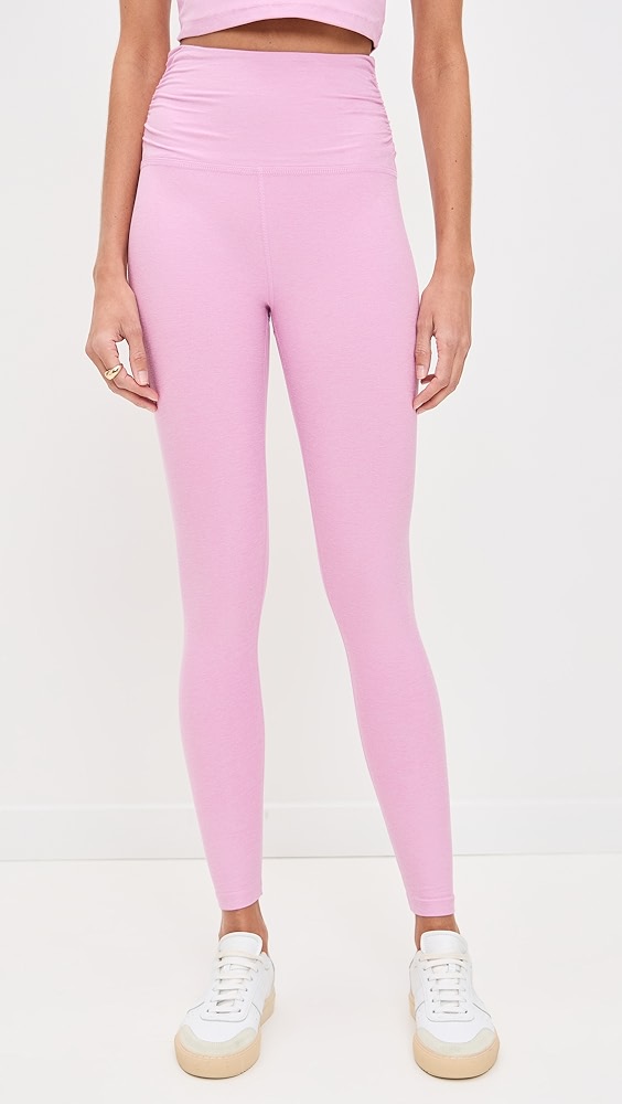 Pink ruched leggings on a model.