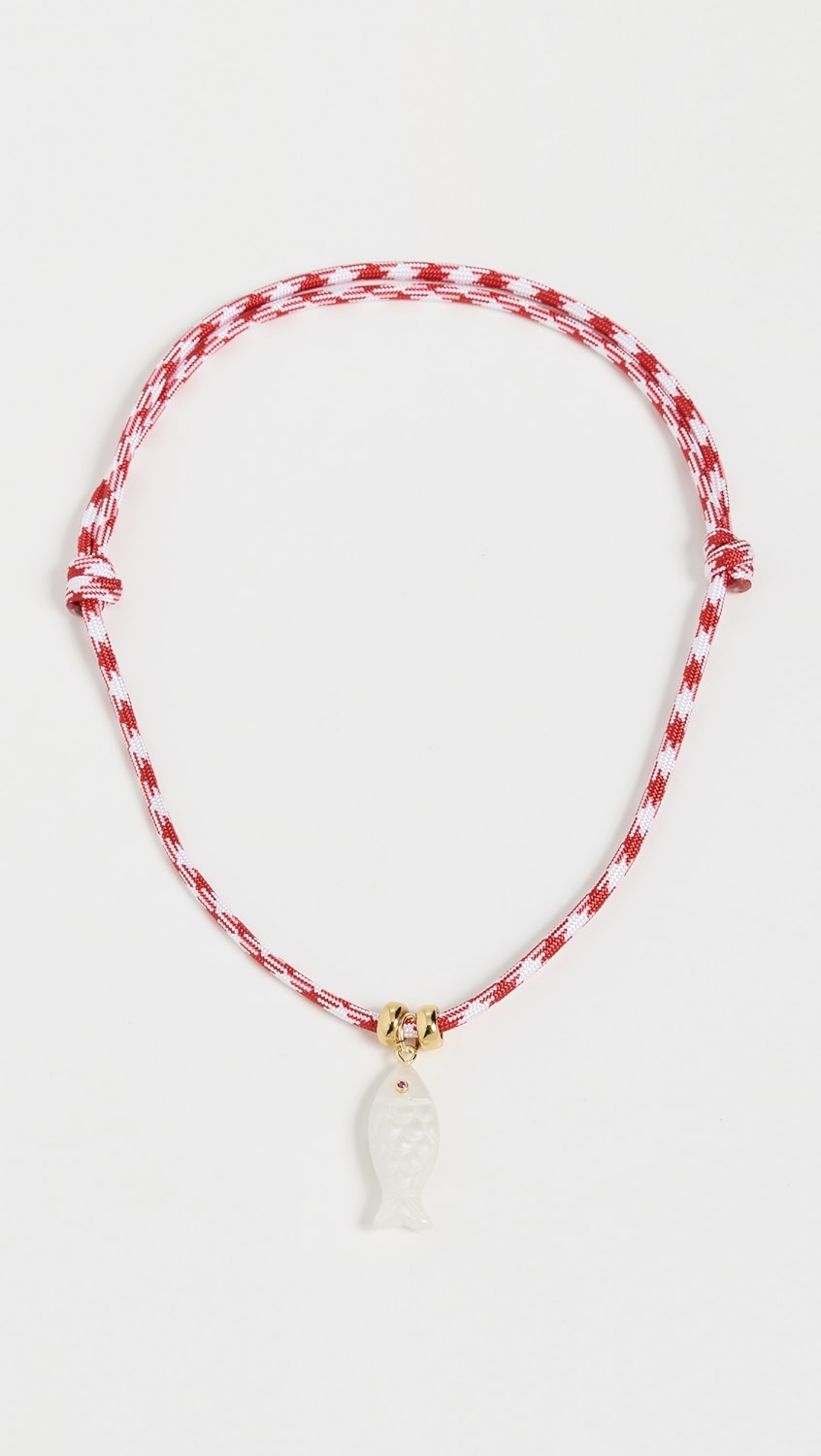 Red and white rope necklace with gold details and a white fish pendant.