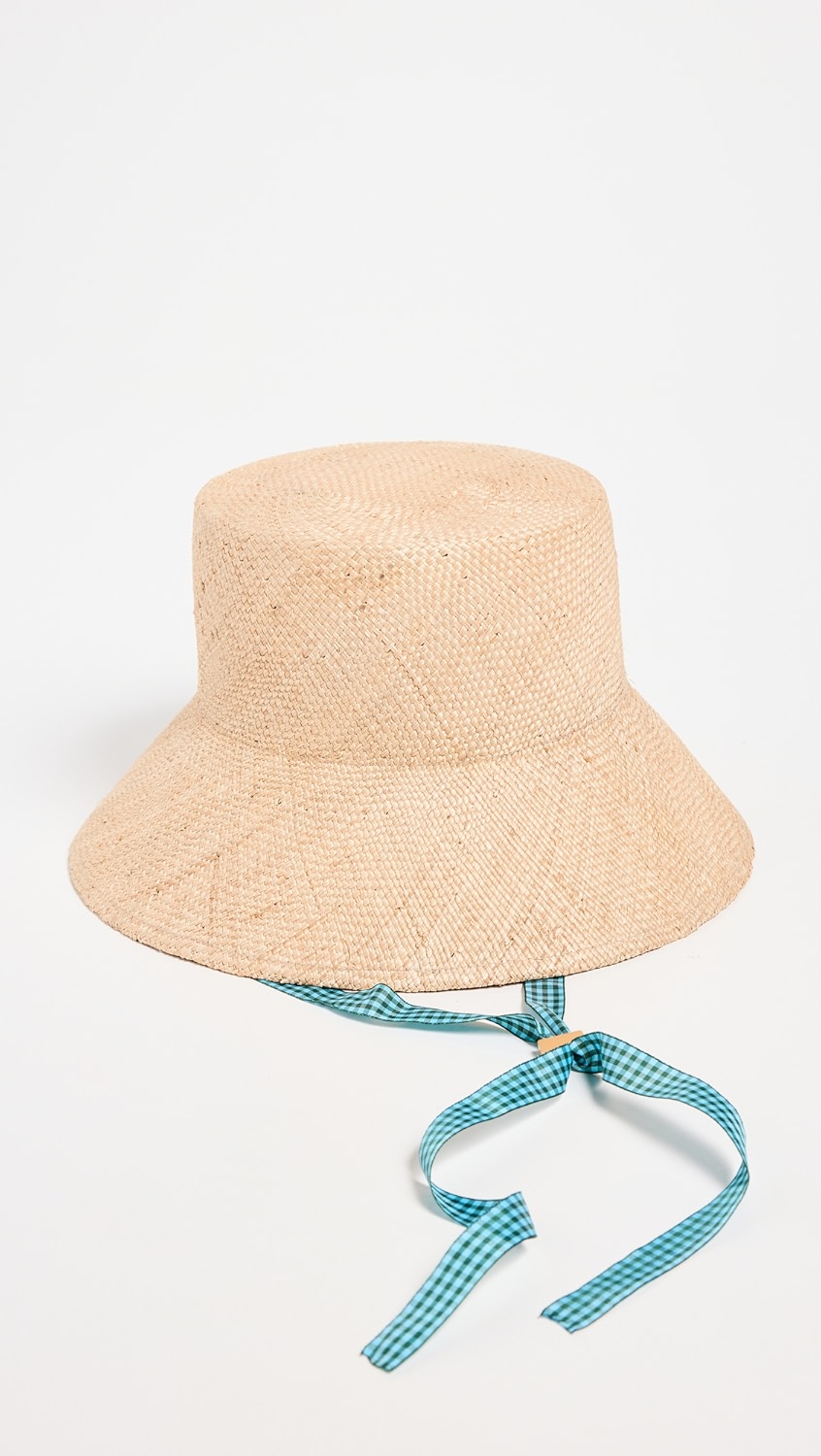 Tan woven hat with blue gingham tie.