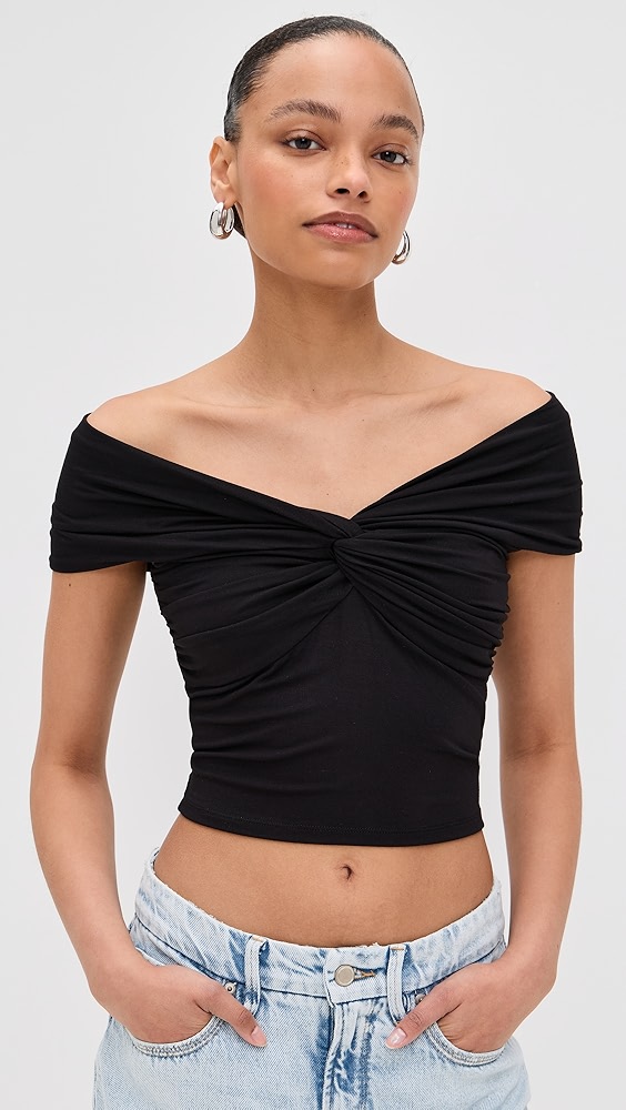 Black off the shoulder crop top on a model, which is one of the night out essentials.