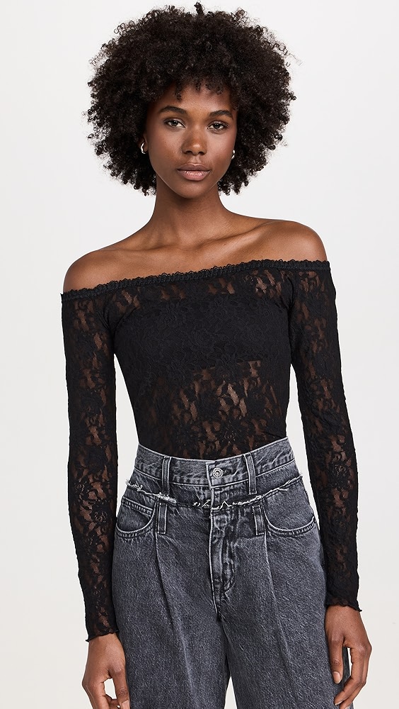 Black off the shoulder lace bodysuit on a model.