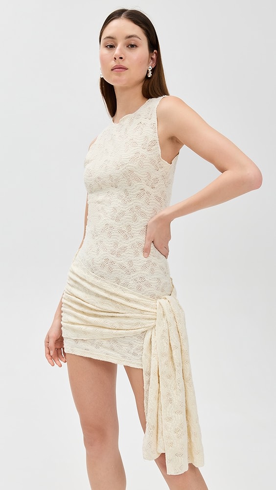 Off white patterned mini dress on a model, which is one of the night out essentials.
