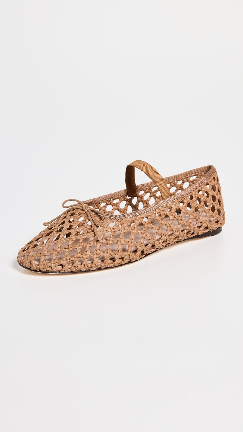 Tan raffia flats with a bow and strap.