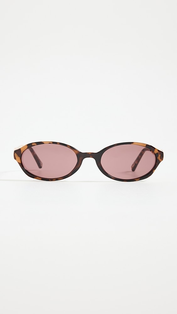 Rounded tortoise shell sunglasses with purple lenses.