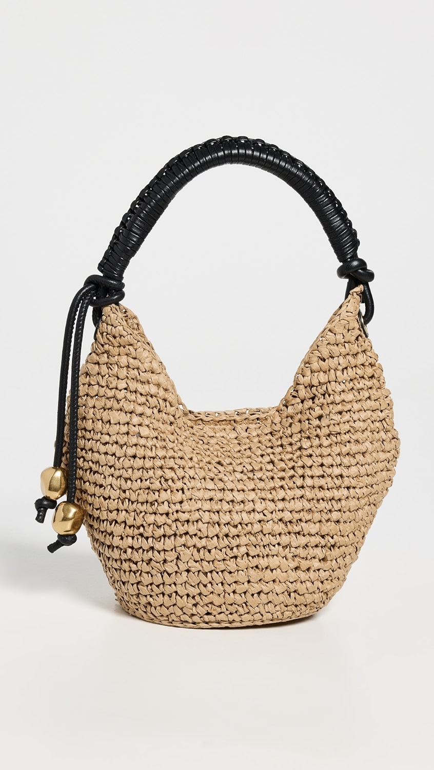 Raffia bag with black straps and gold details.