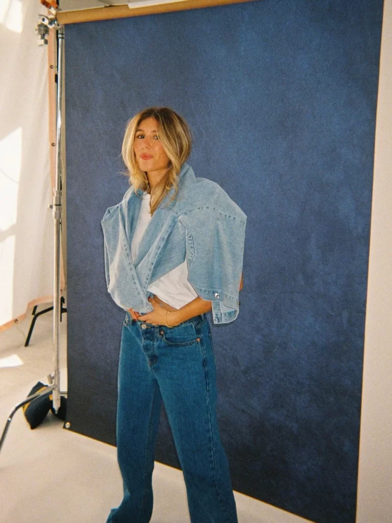Founder Chelsea wearing a denim jacket, white t shirt, and jeans.