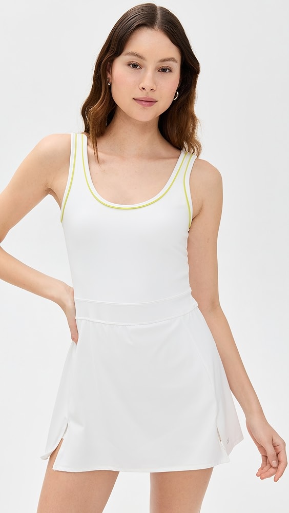 White active dress with yellow trim on a model.
