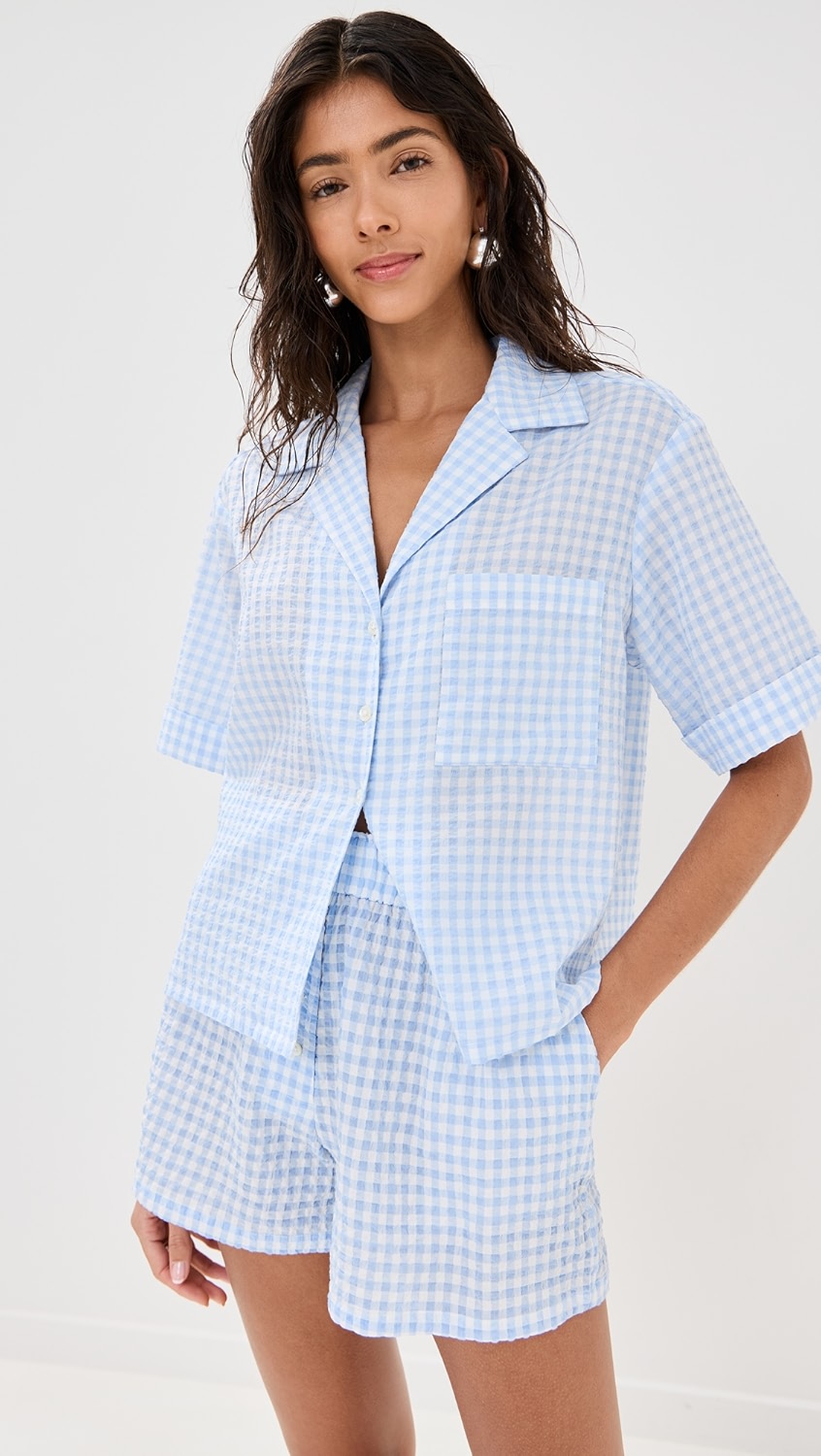 Light blue and white gingham short sleeve button-up and matching shorts on a model.