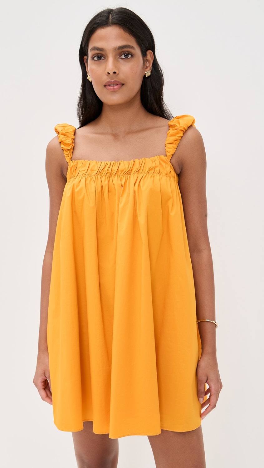 Orange square neckline relaxed mini dress with ruffle straps on a model.