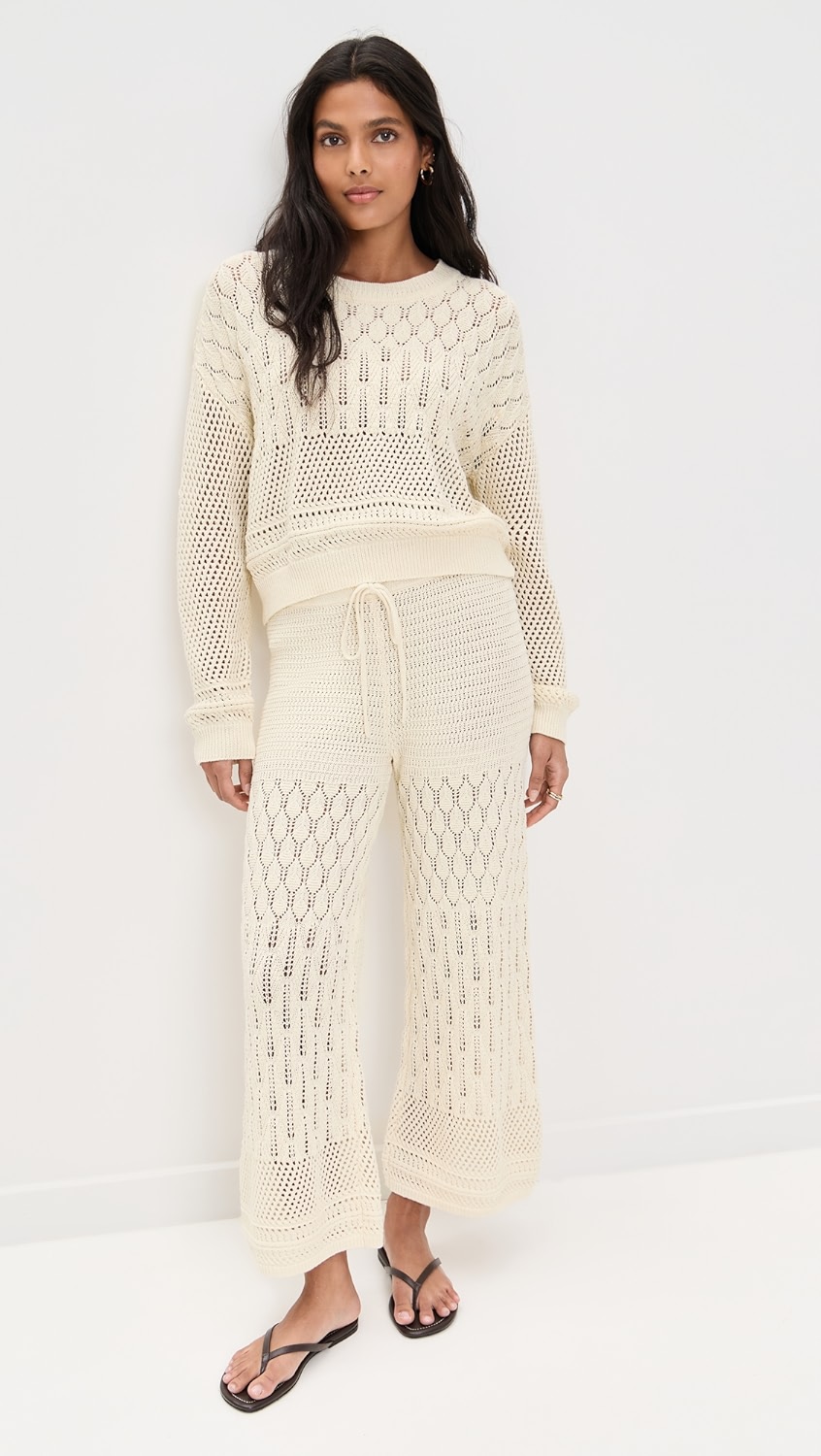 Cream crochet long-sleeve and matching capri pants on a model.