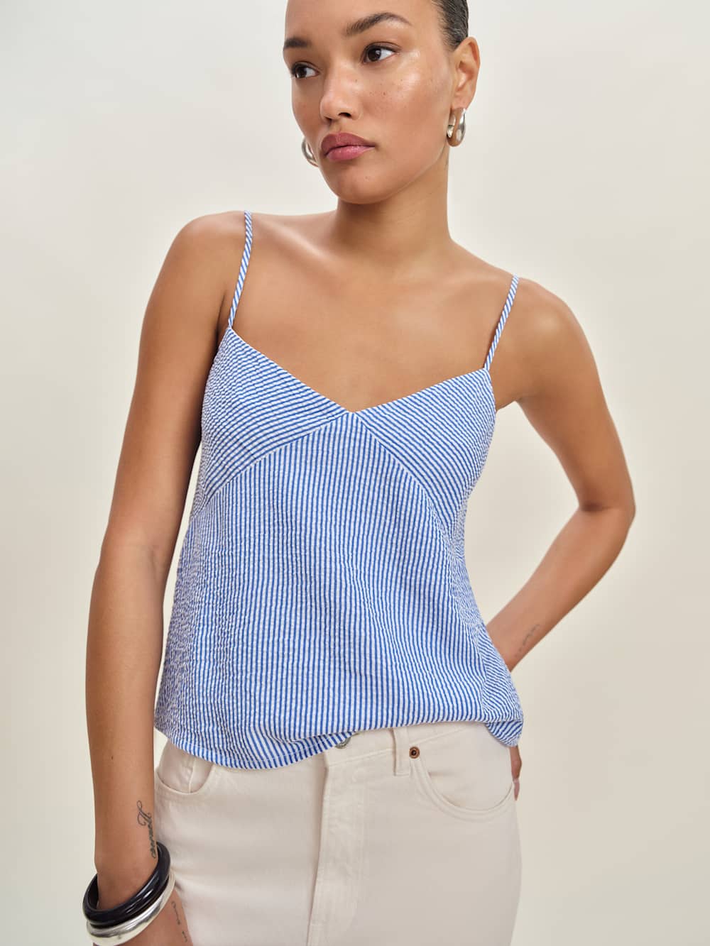 Blue and white striped spaghetti strap tank top on a model.