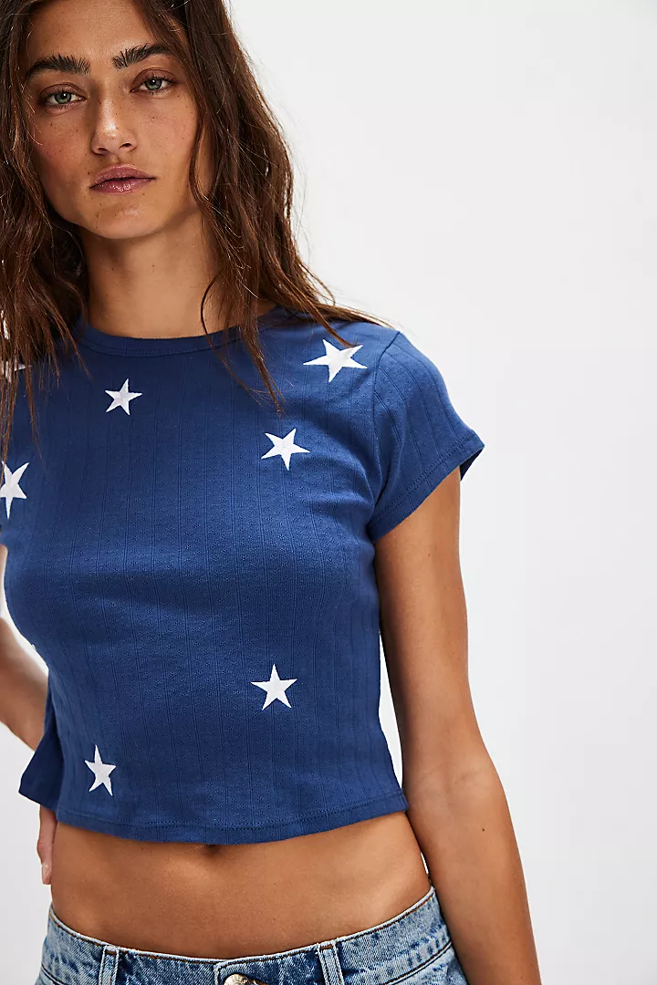 Navy cropped t shirt with white stars on a model.