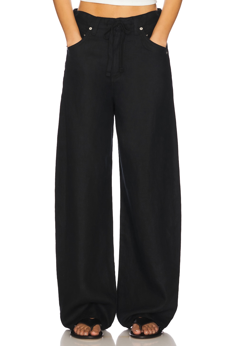 Black drawstring trousers on a model.