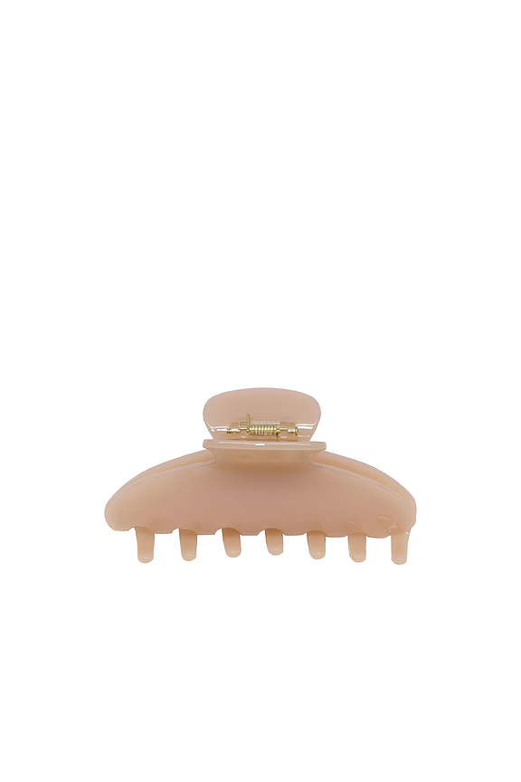 Tan claw clip, which is one of the work from home essentials.