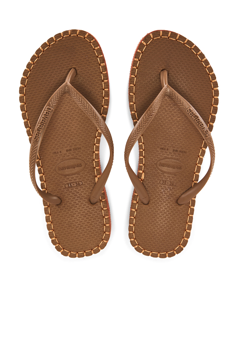 Brown flip flops with gold stitching, which is one of the stylish shoes.