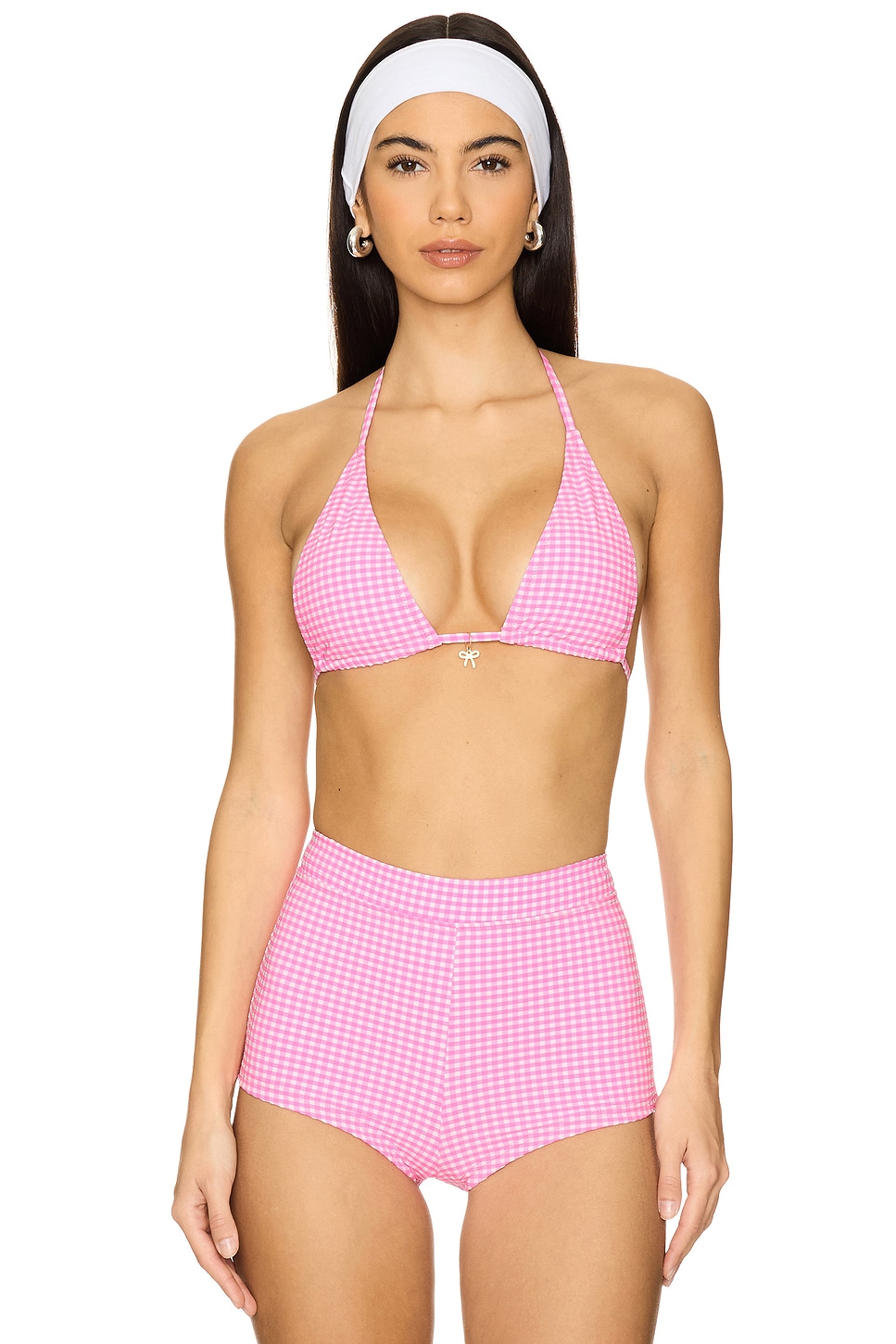 Bright pink and white checkered triangle bikini on a model.