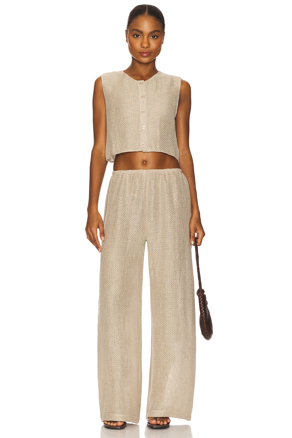 Tan button up tank top and matching pants on a model.