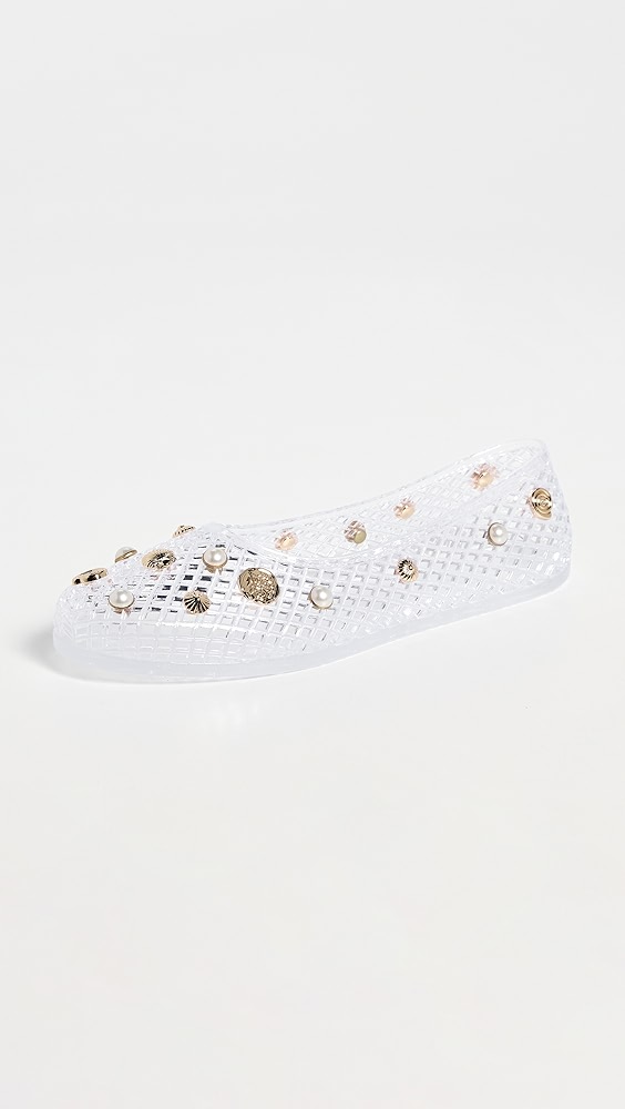 Clear jelly ballet flat with pearl and gold embellishments.