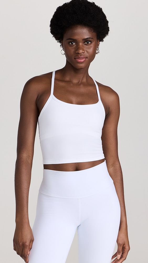 White active tank top on a model, which is one of the trendy activewear pieces.