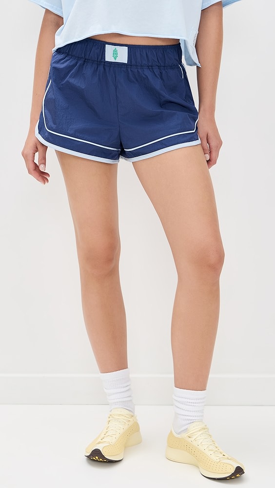 Navy and light blue active shorts on a model.