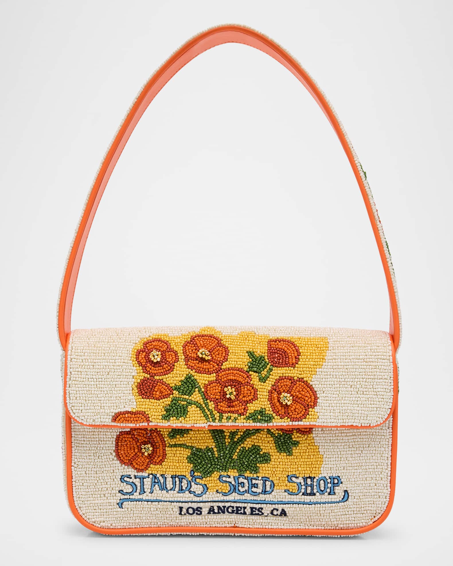 Off white and orange STAUD beaded bag with orange flower designs and text that says "STAUD'S SEED SHOP."
