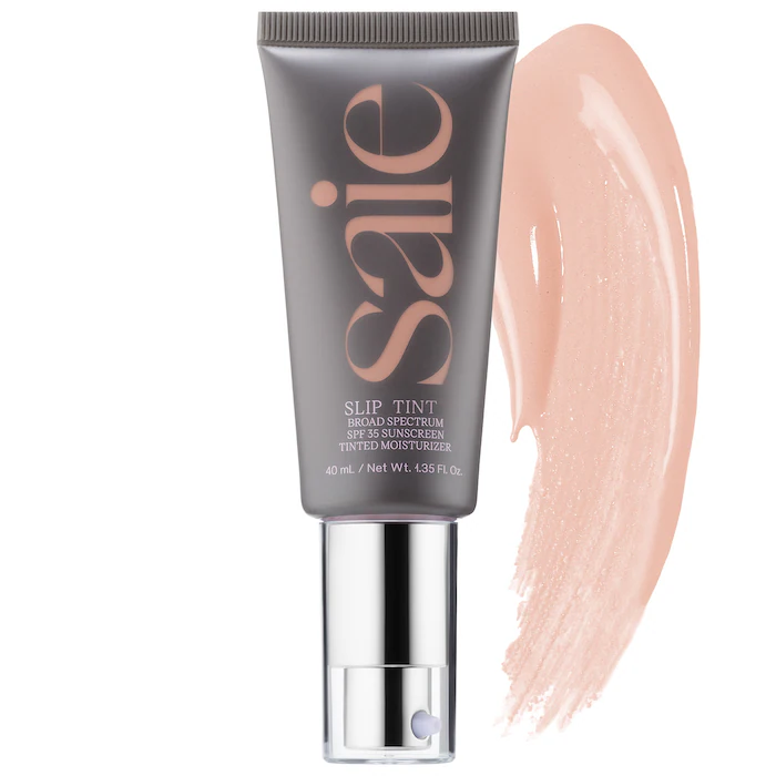 Grey and silver Saie bottle with a light pink tinted moisturizer swatch.