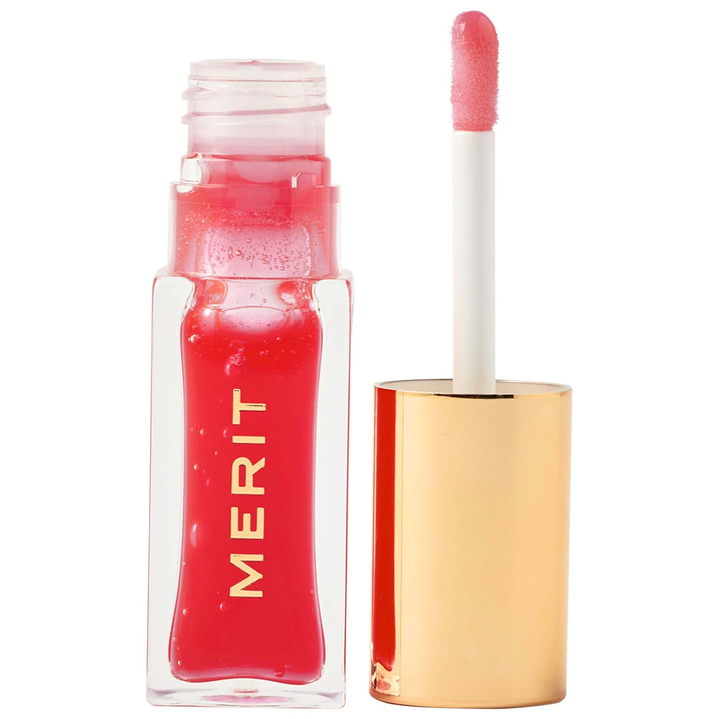 Clear and gold MERIT tube with applicator of bright pink tinted lip oil.