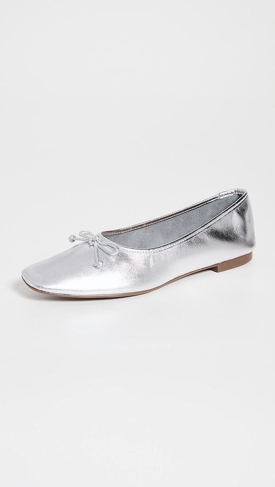 Shiny silver shoe with a bow.