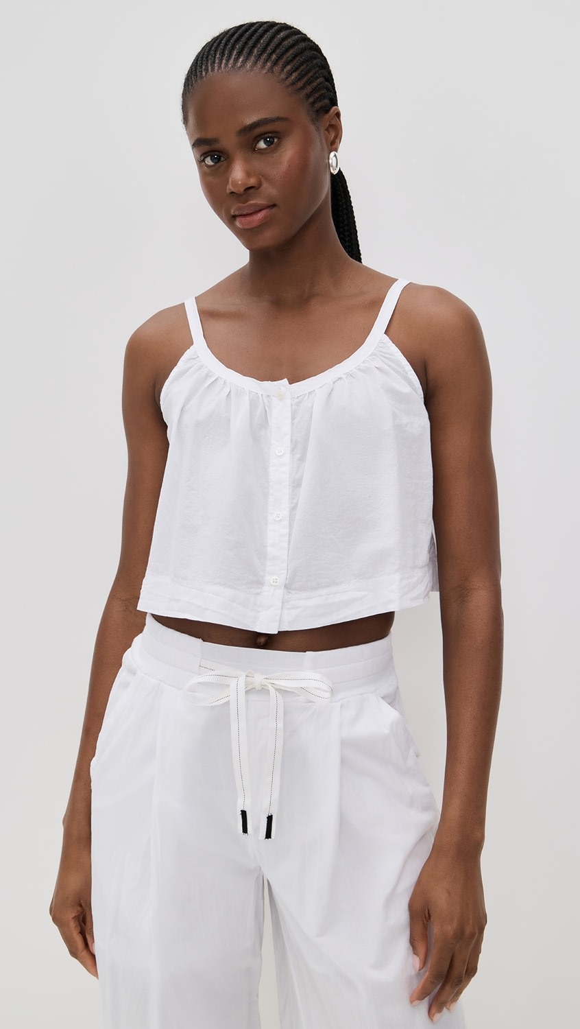White flowy button up cropped tank top on a model.