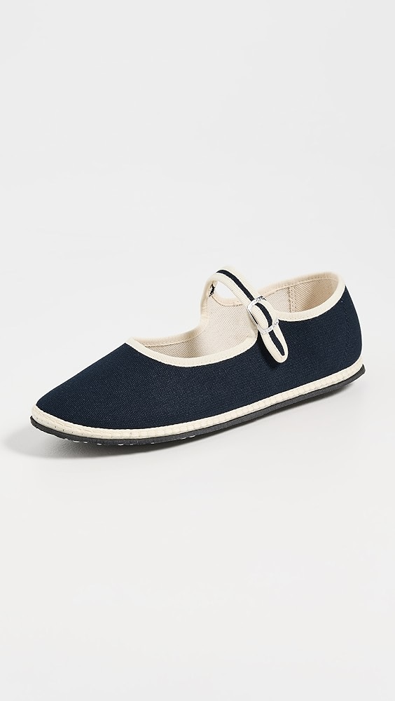Black and white two-tone shoe with a strap.